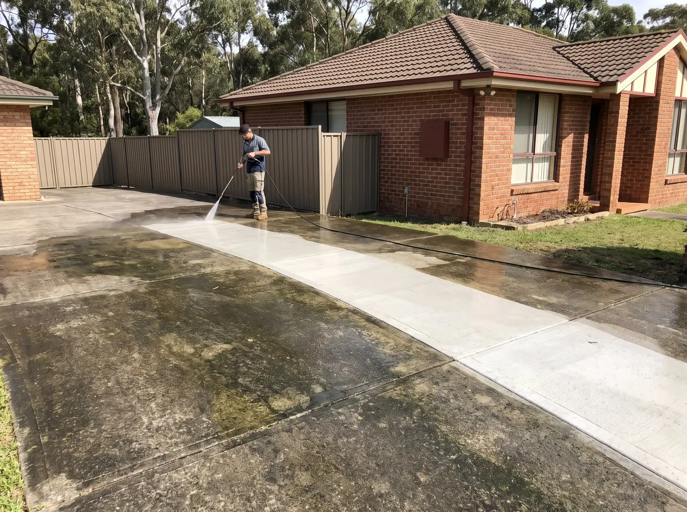 Pressure washing a concrete driveway