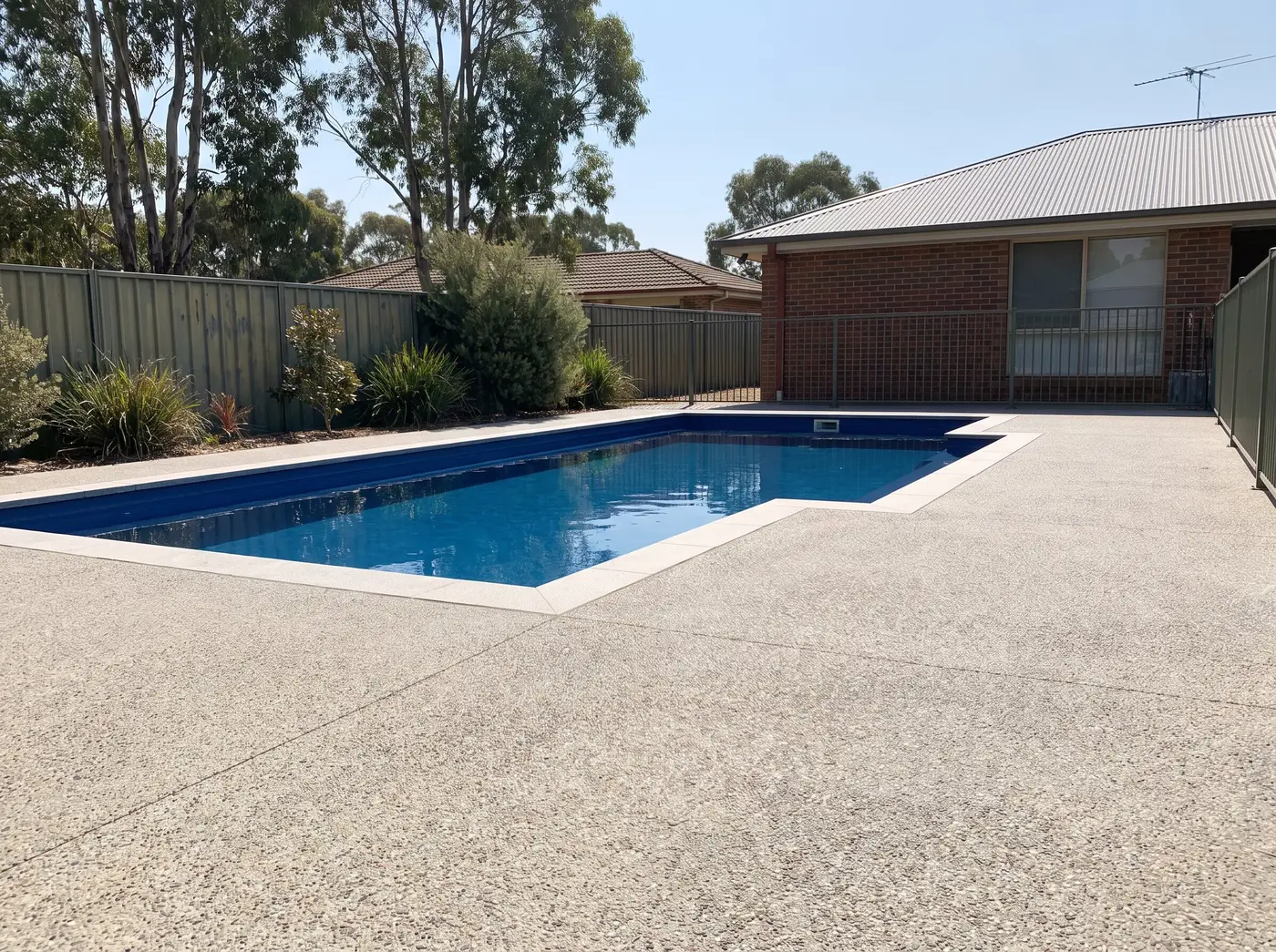 Concrete surround around a backyard pool