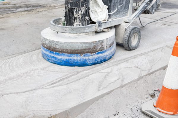 Working Grinding machine polishing a Concrete surface of a city road
